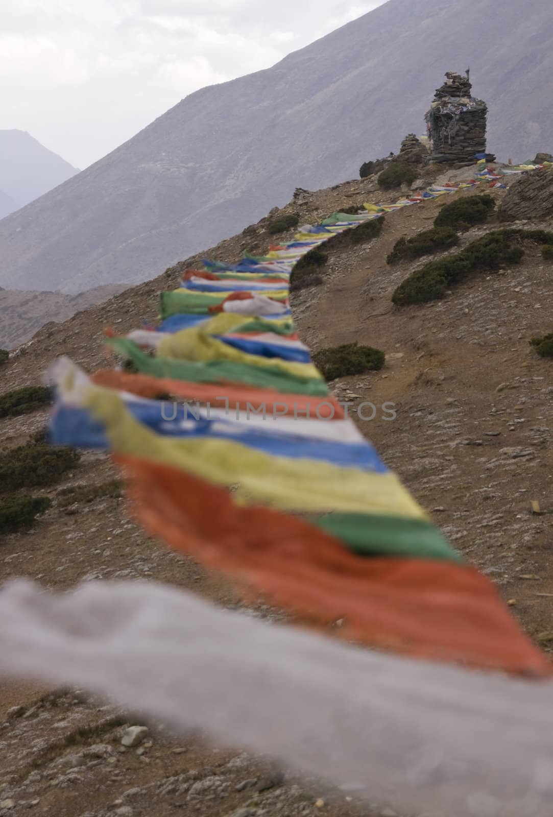 Prayers flags blowing in the wind on a mountainside in the Himalaya mountains of Nepal
