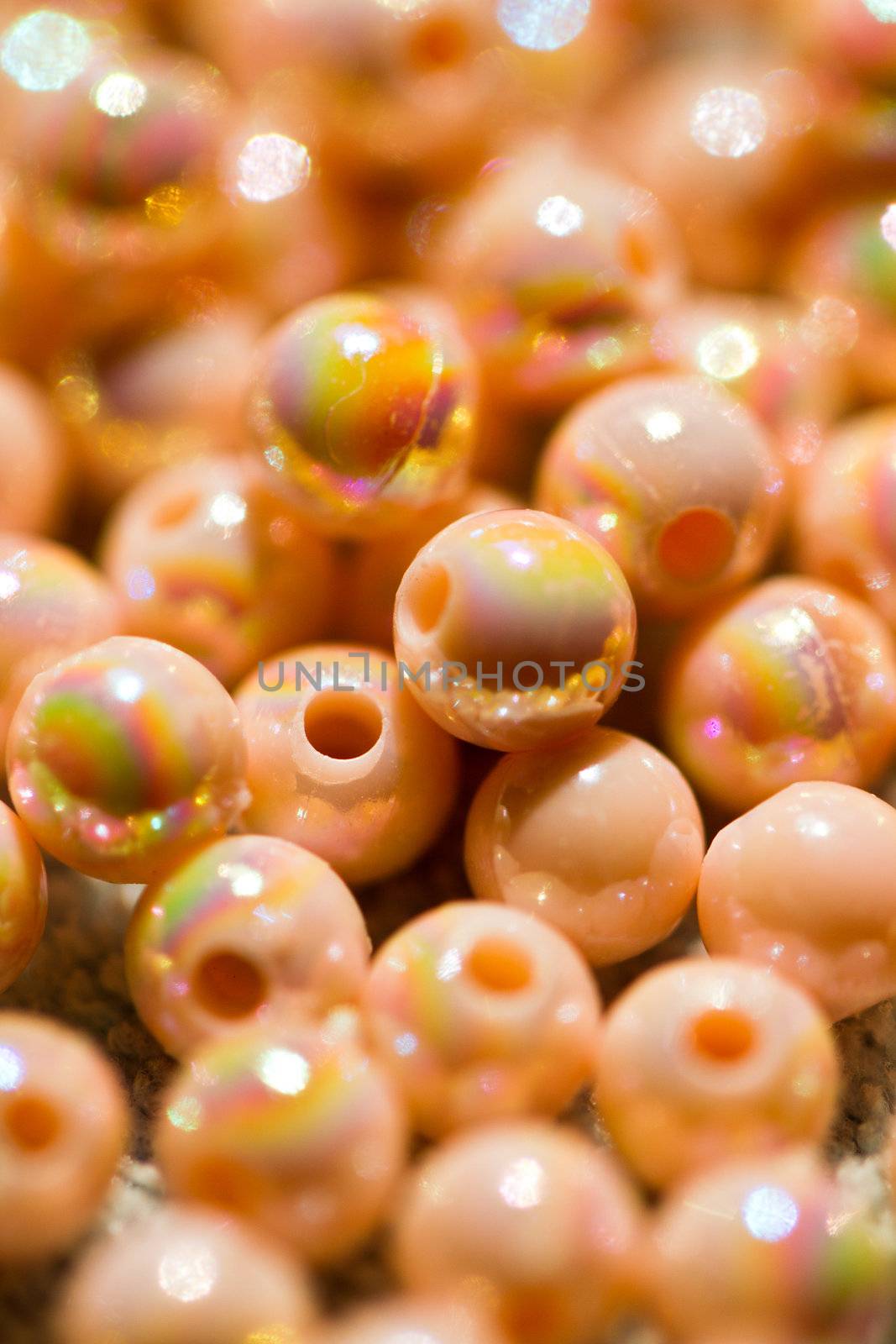 beige colored beads shine under sunlight in portrait orientation