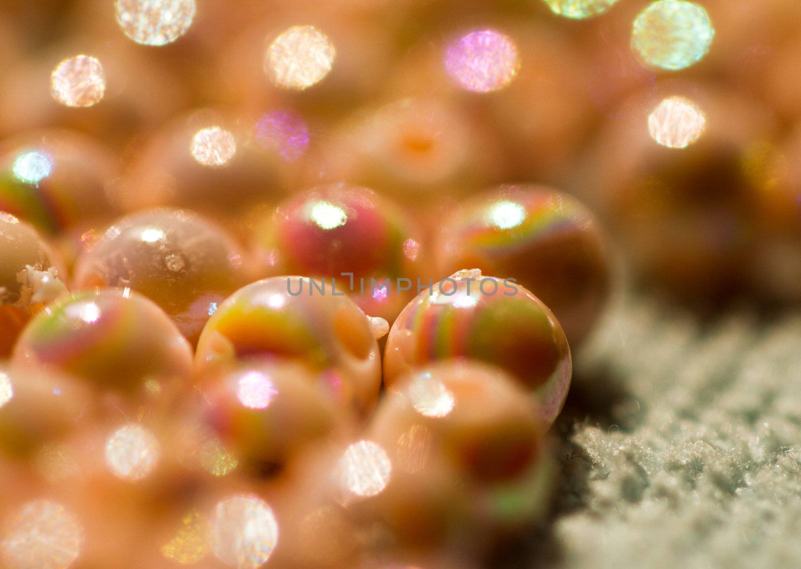 close up of beige colored beads shine under sunlight in landscape orientation