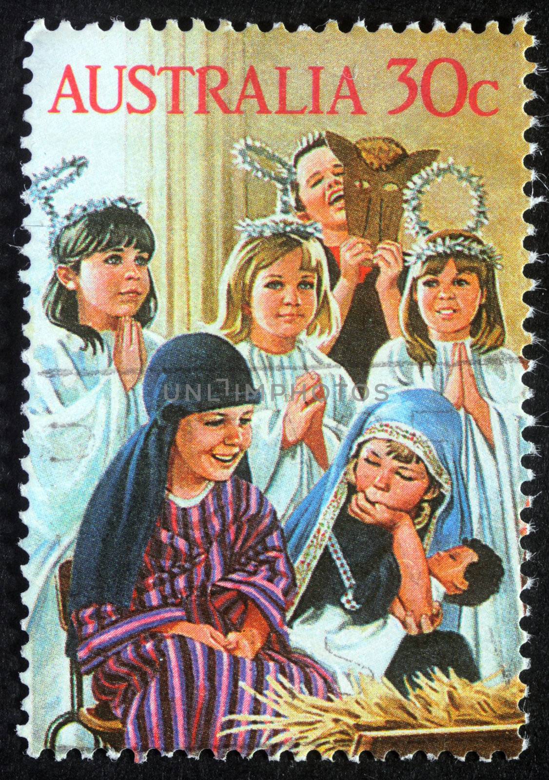 AUSTRALIA - CIRCA 2004: A greeting Christmas stamp printed in Australia shows children play to the Holy Family