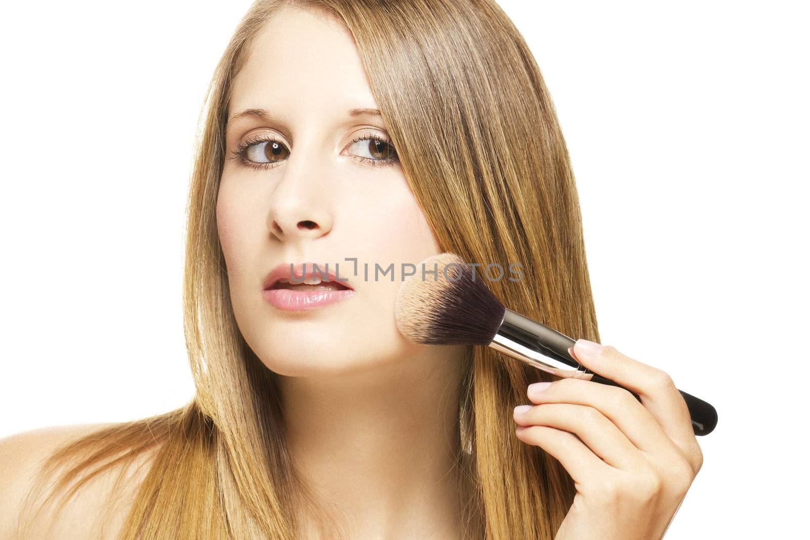 beautiful woman put on makeup with a brush on white background