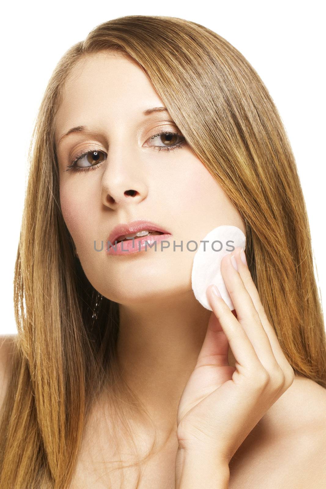 young woman removing makeup on white background