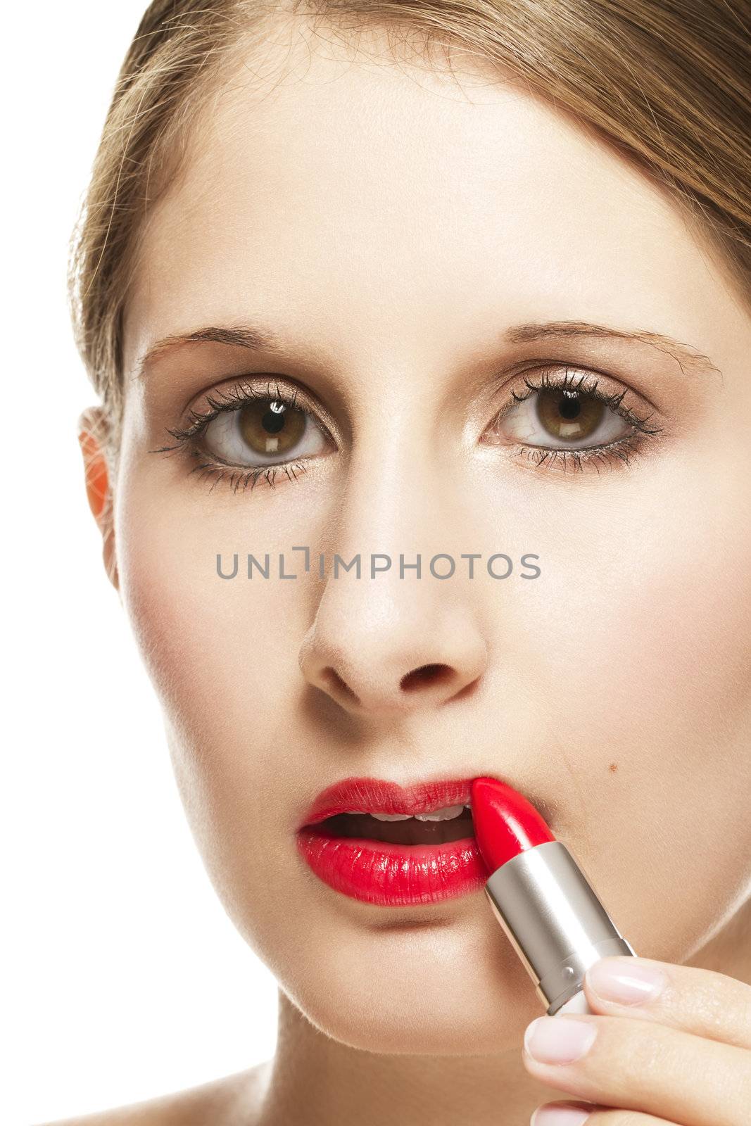 closeup of a beautiful woman applying lipstick on white background