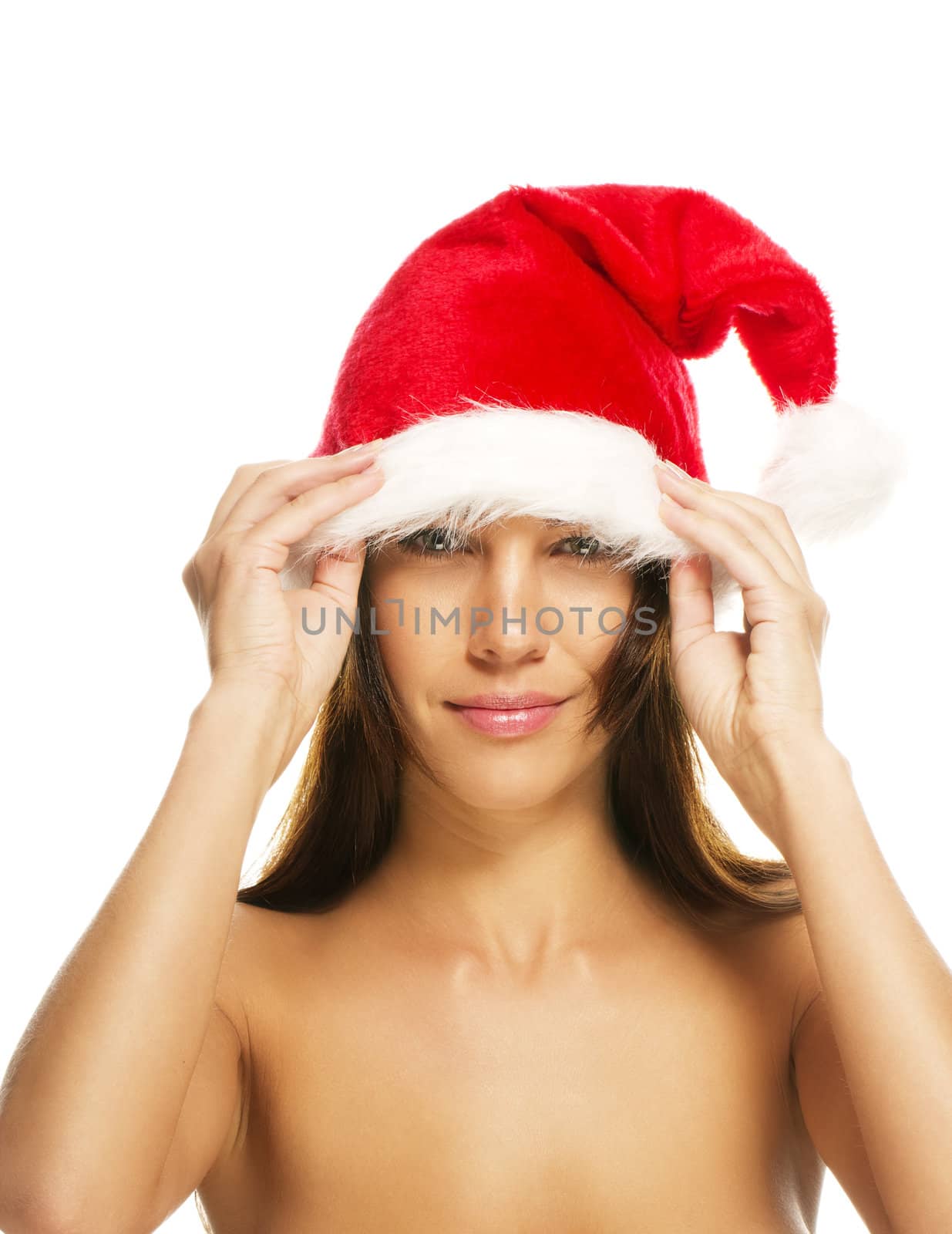 beautiful brunette woman put on santas hat on white background