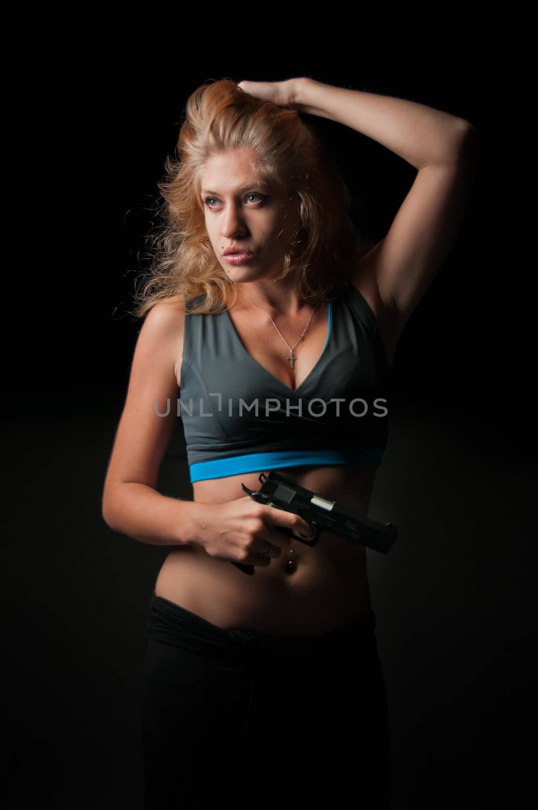 Beauty woman with pistol portrait on black background