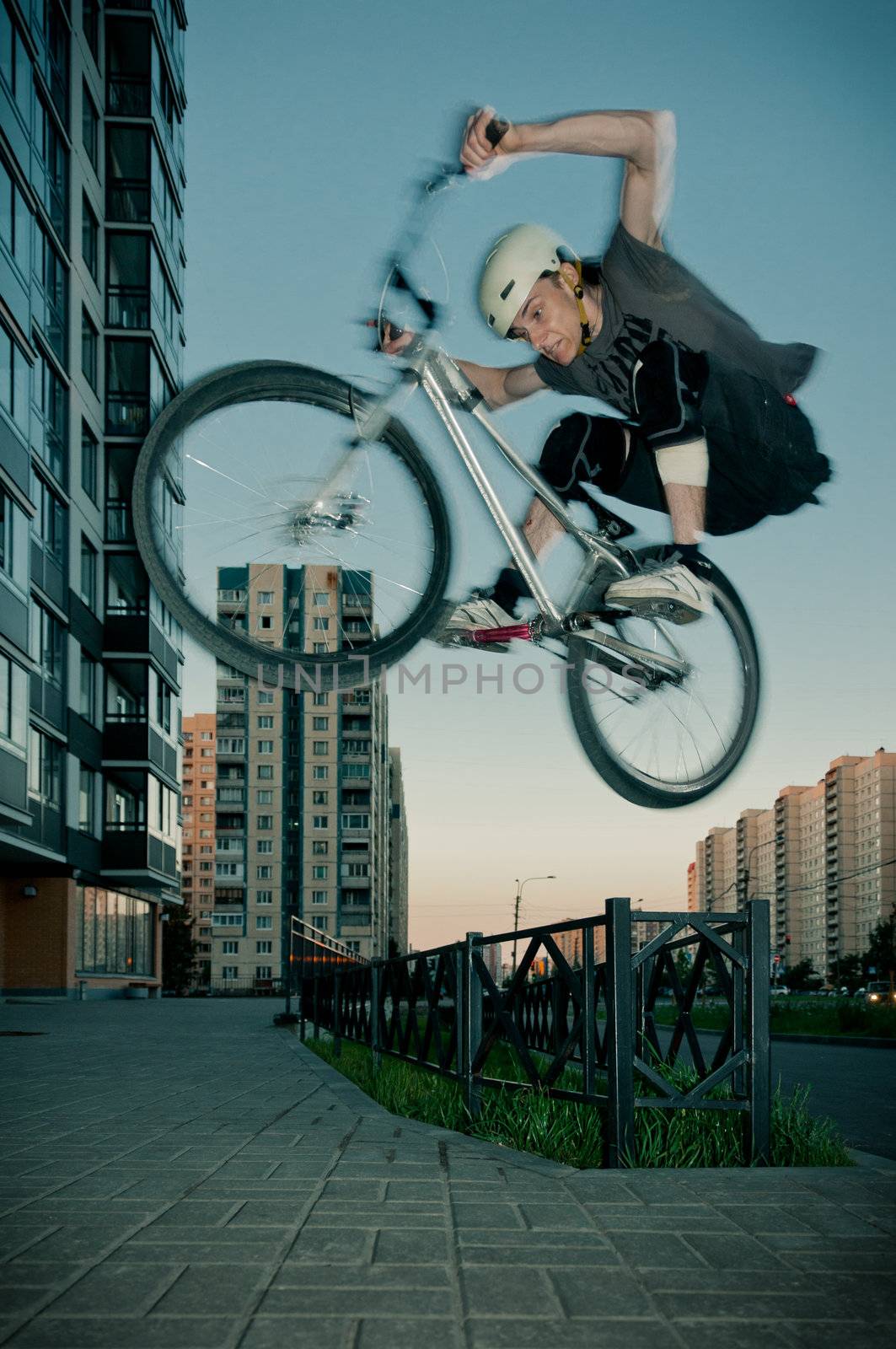 Biker jumping through fence by dmitryelagin