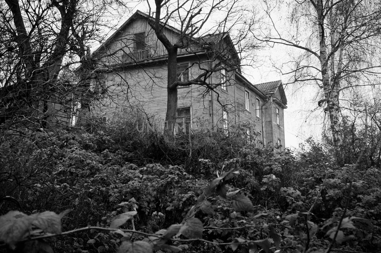 Lonely, dark abandoned house on the hill, black and white