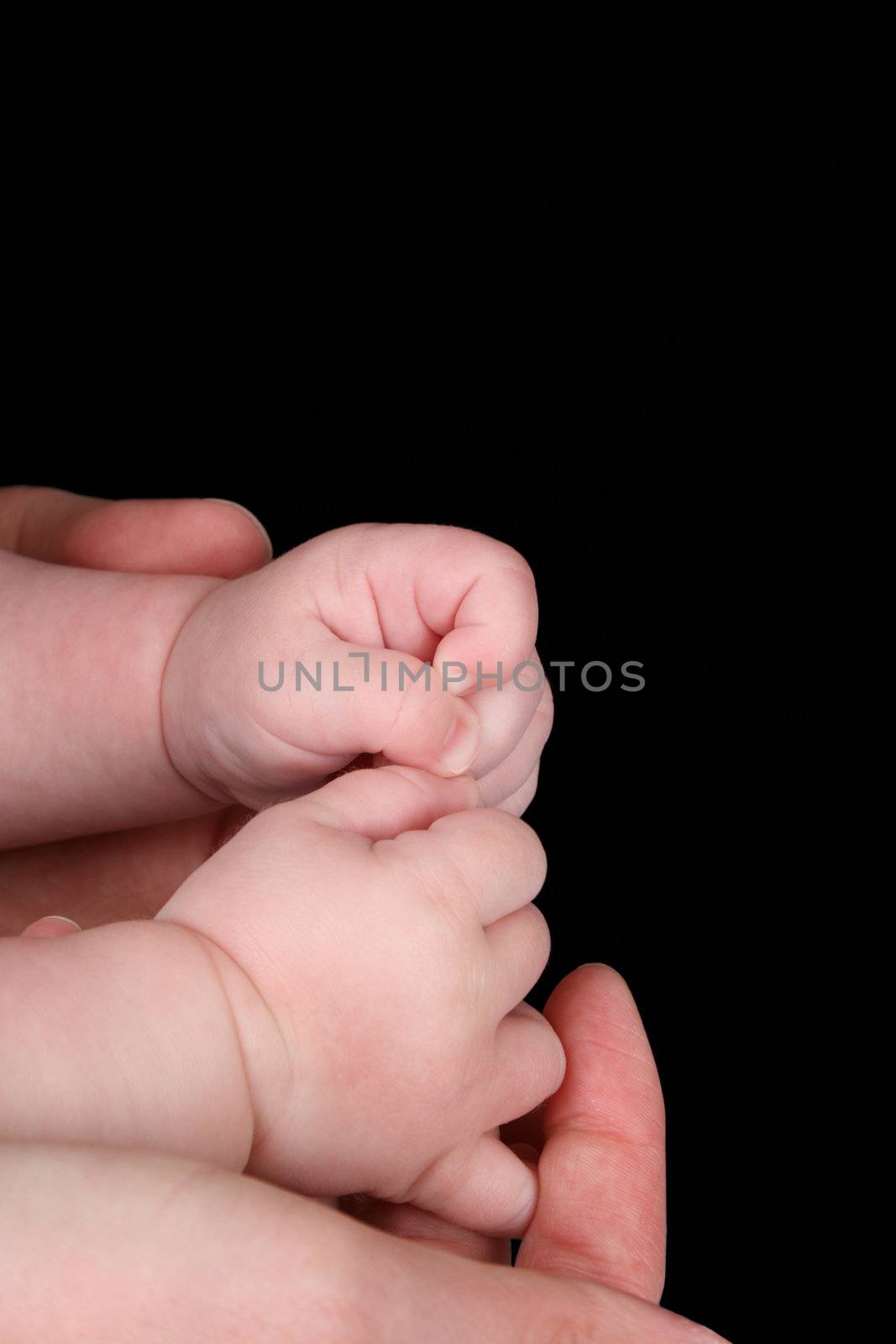 Caucasian mother and baby, baby holding mother's thumb 