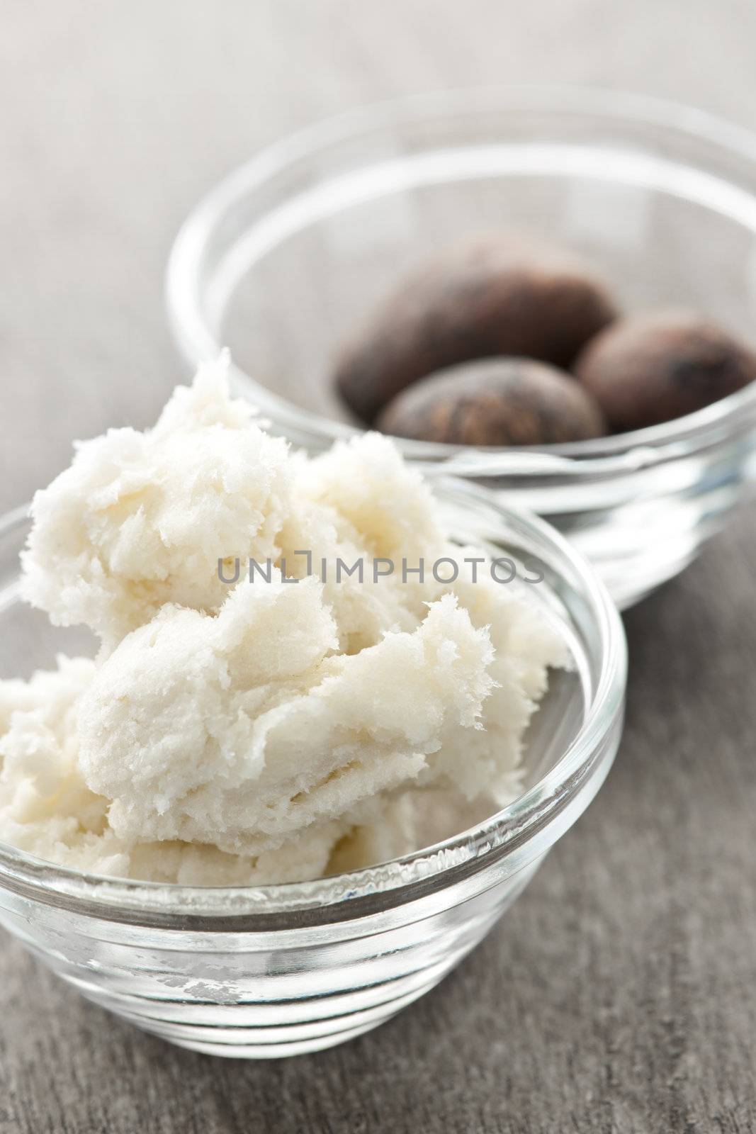 Shea butter and nuts in bowls by elenathewise