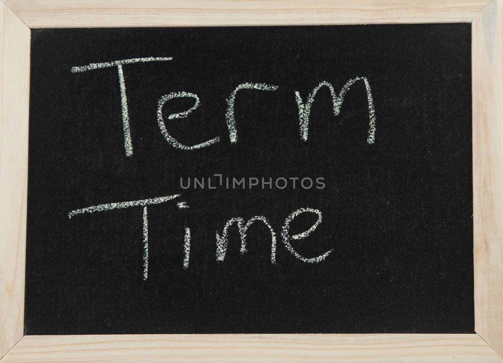 A black board with a wooden frame and the word 'TERM TIME' written in chalk.