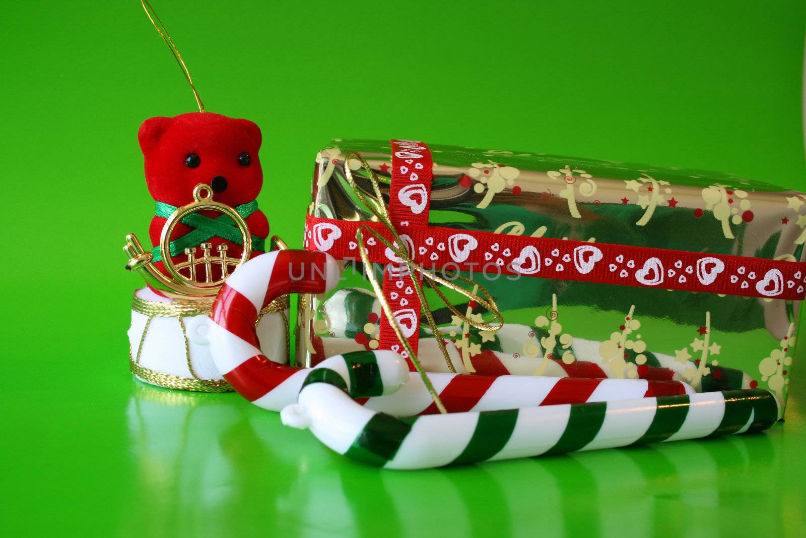 Christmas decorations on a green background with a wrapped present
