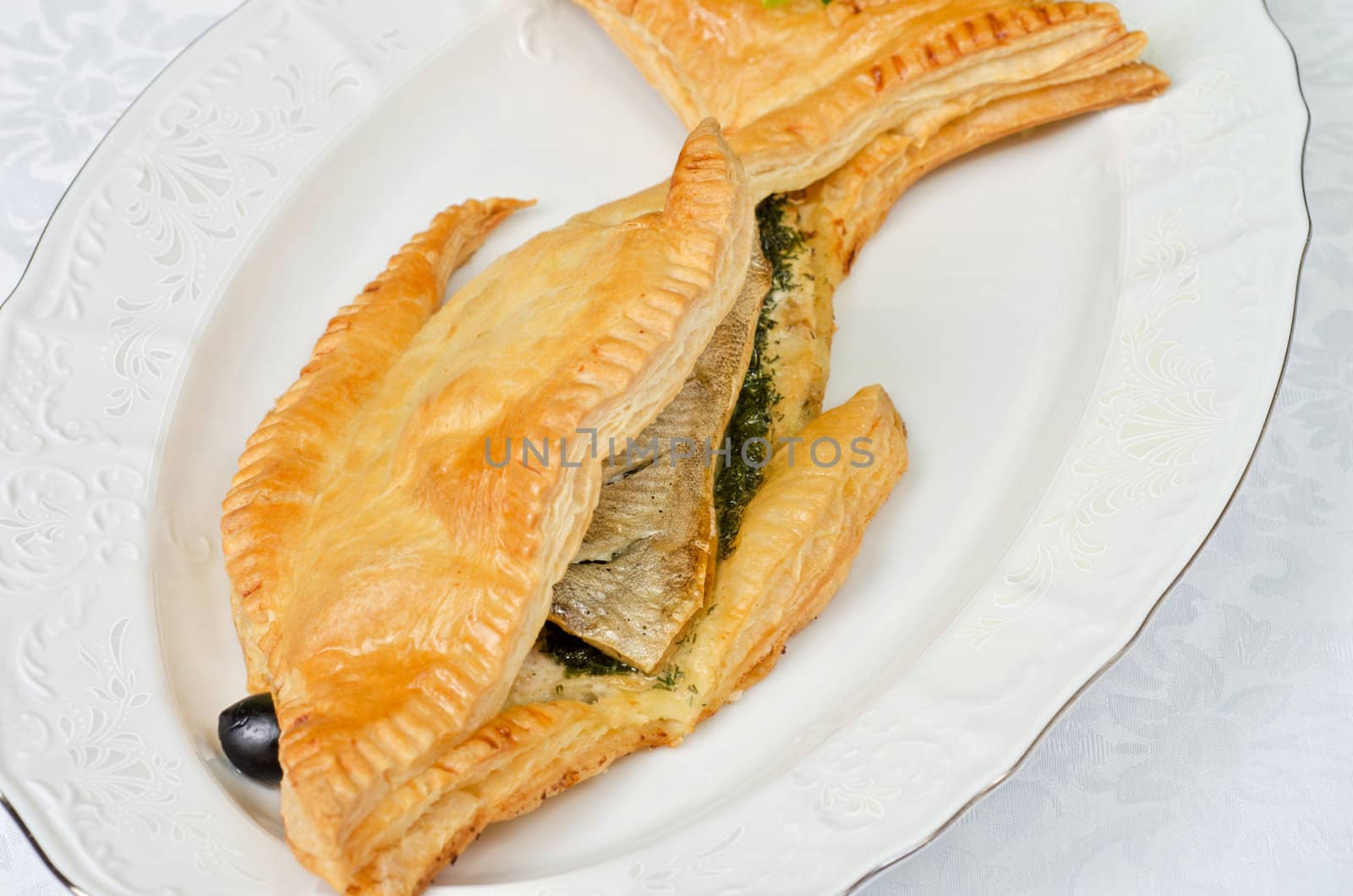 tasty dish of trout fish baked with greens at dough