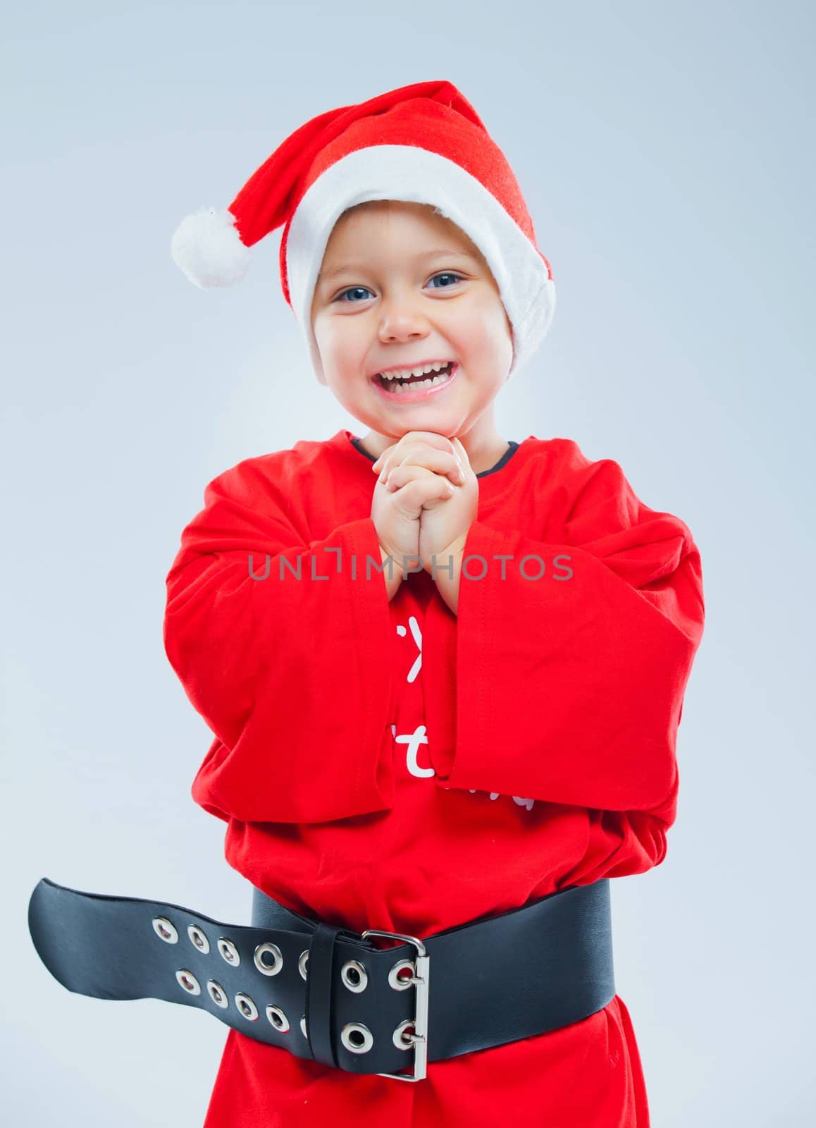 Surprised baby boy in santa claus hat