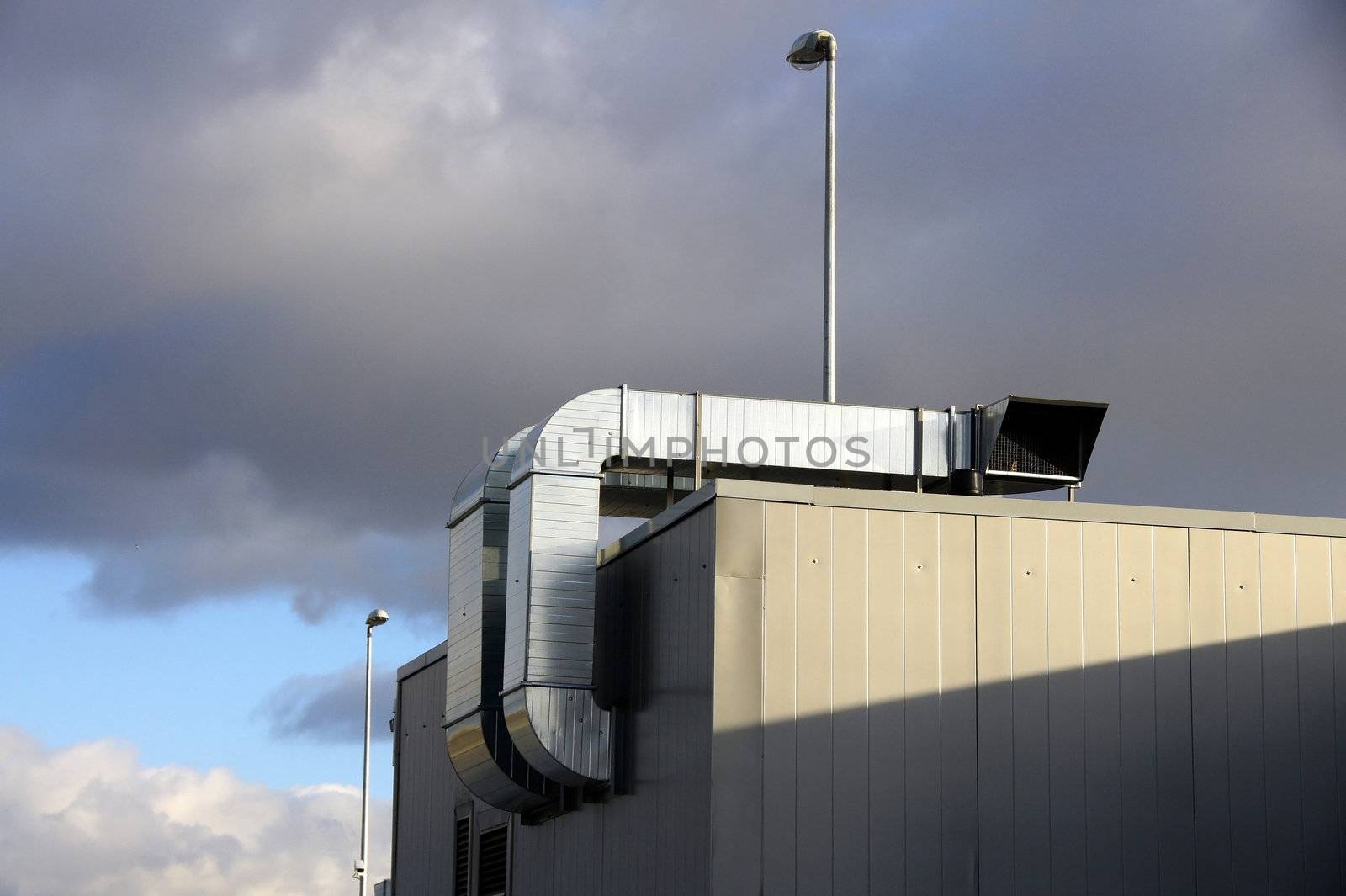 Pipes of ventilation are located on a roof of a  building