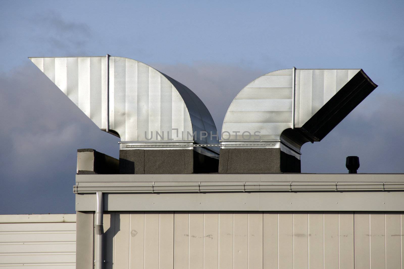 Greater pipes of ventilation on a background of clouds