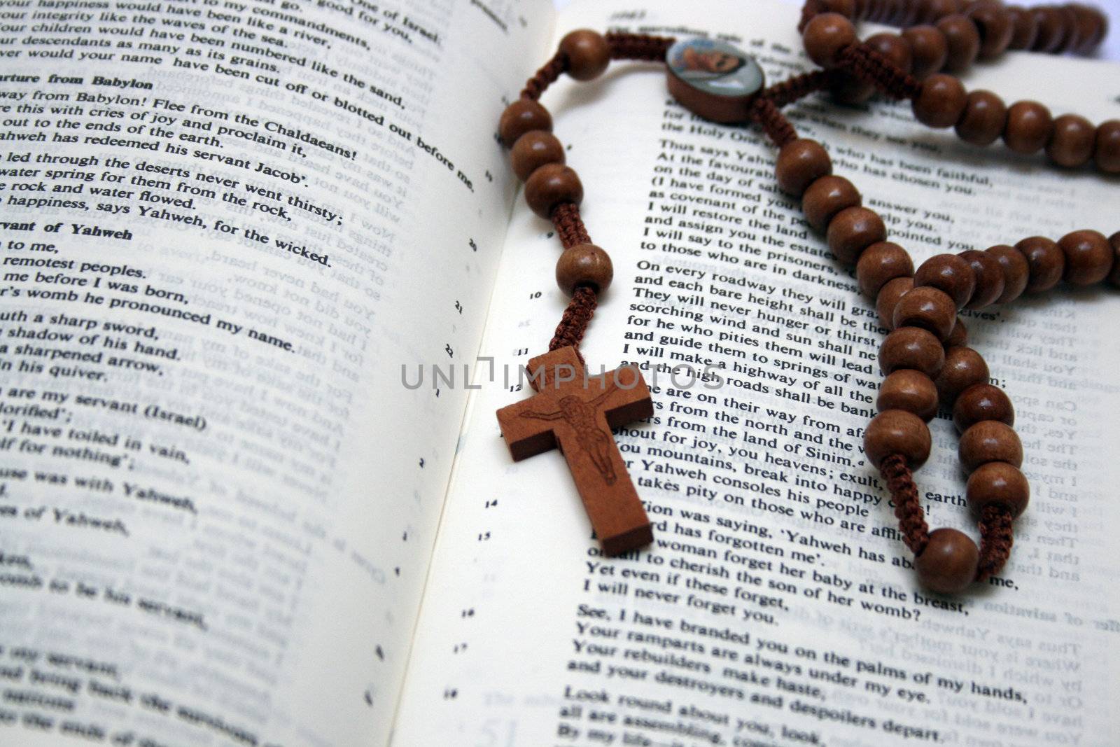 Holy Bible and wooden rosary beads