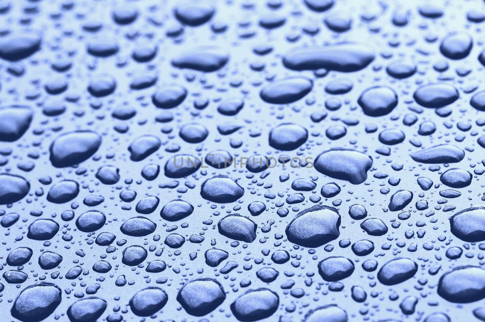 a picture of water drops on metal surface