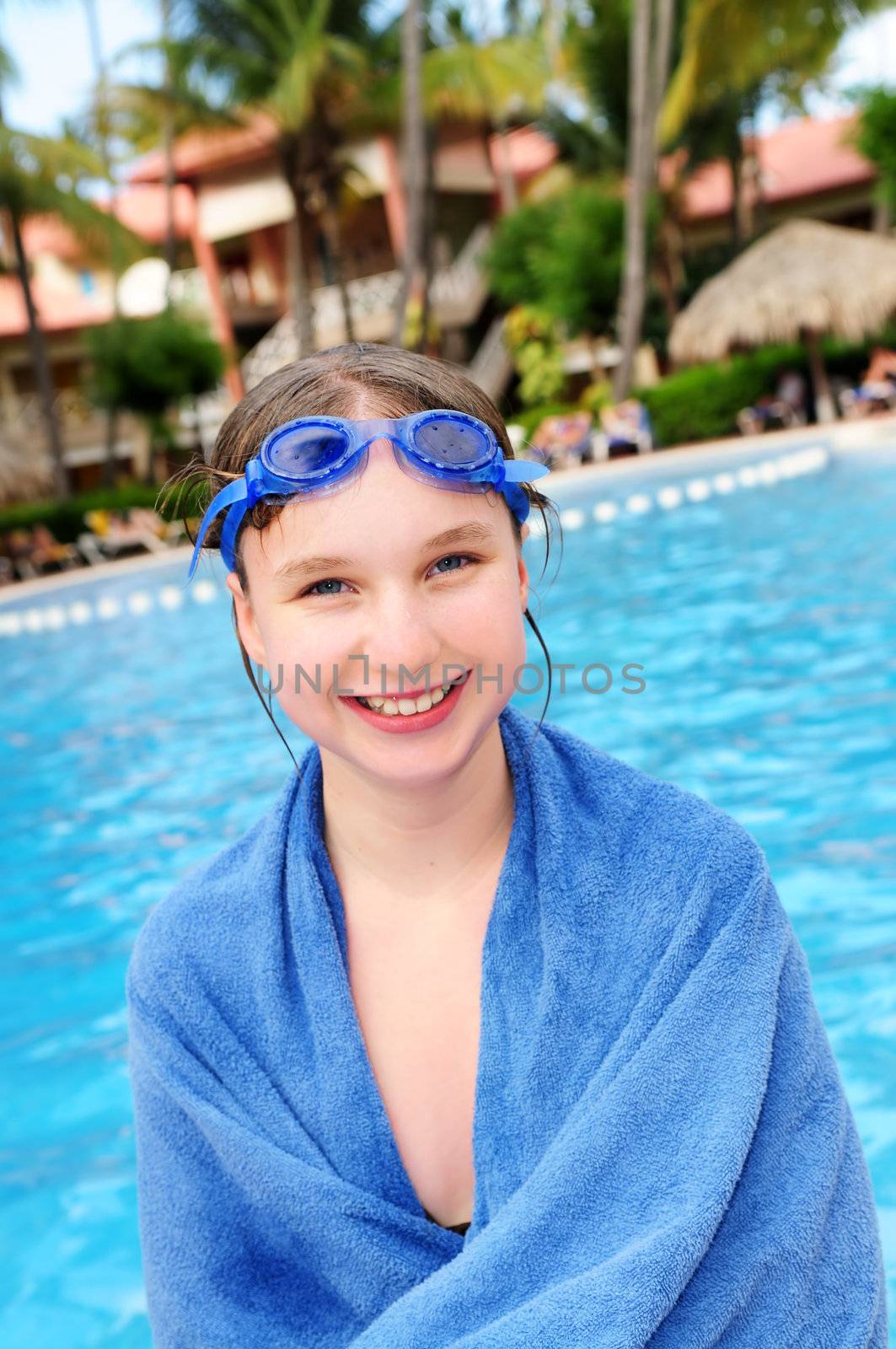 Teenage girl at the swimming pool in tropical resort