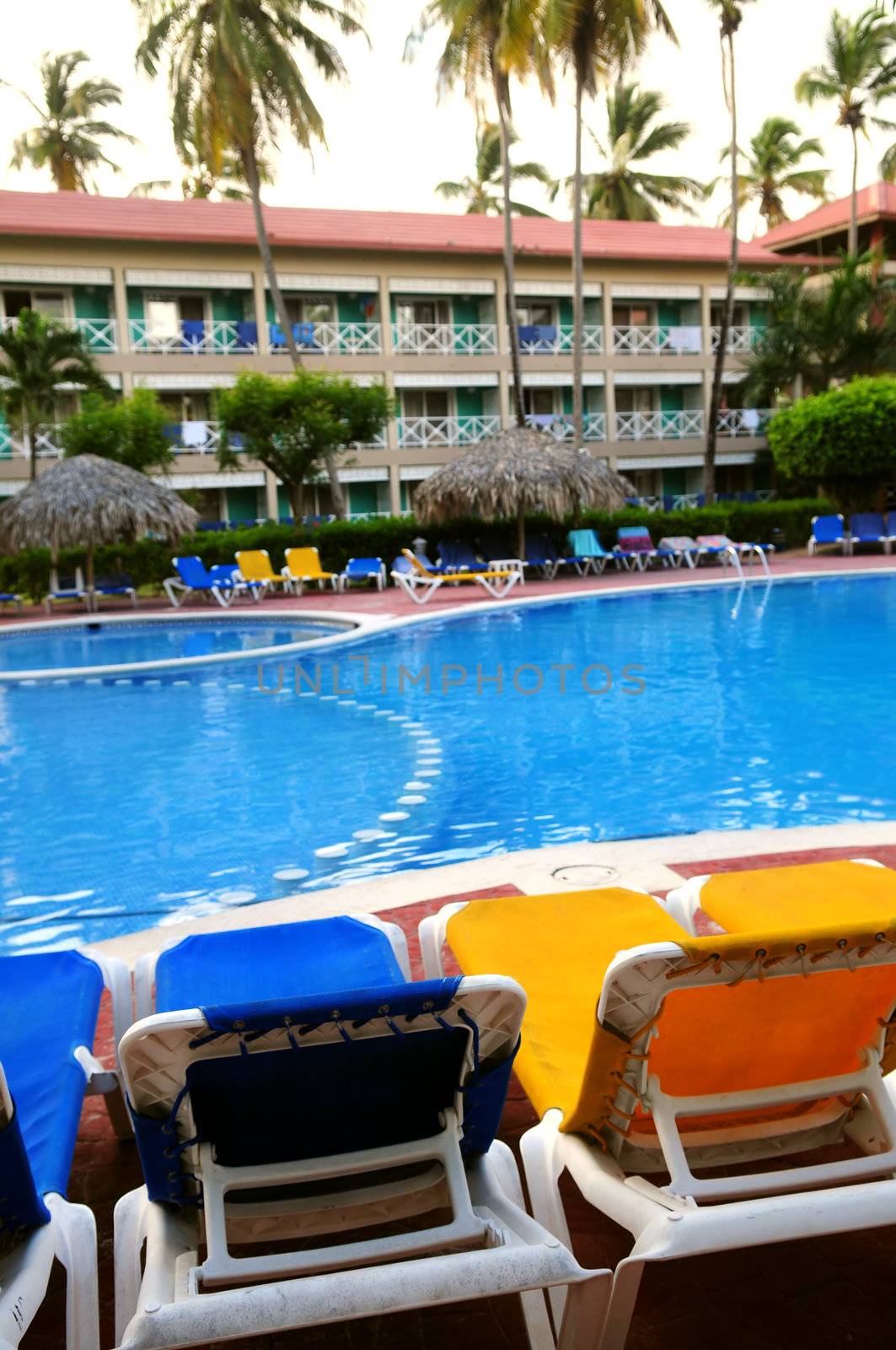 Swimming pool and chairs at tropical resort