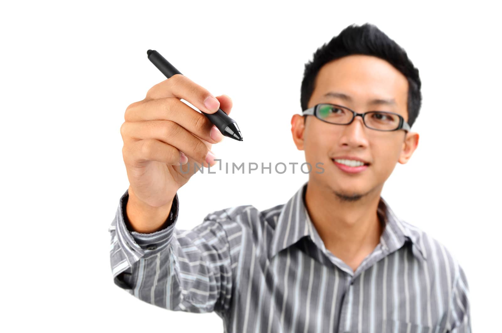 Closeup of young Asian businessman drawing on transparent glass or foil.