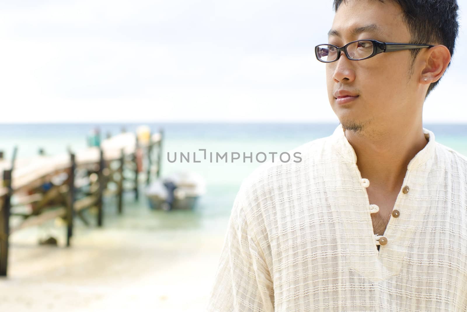 Young man have good time and relax at beautiful beach at seaside