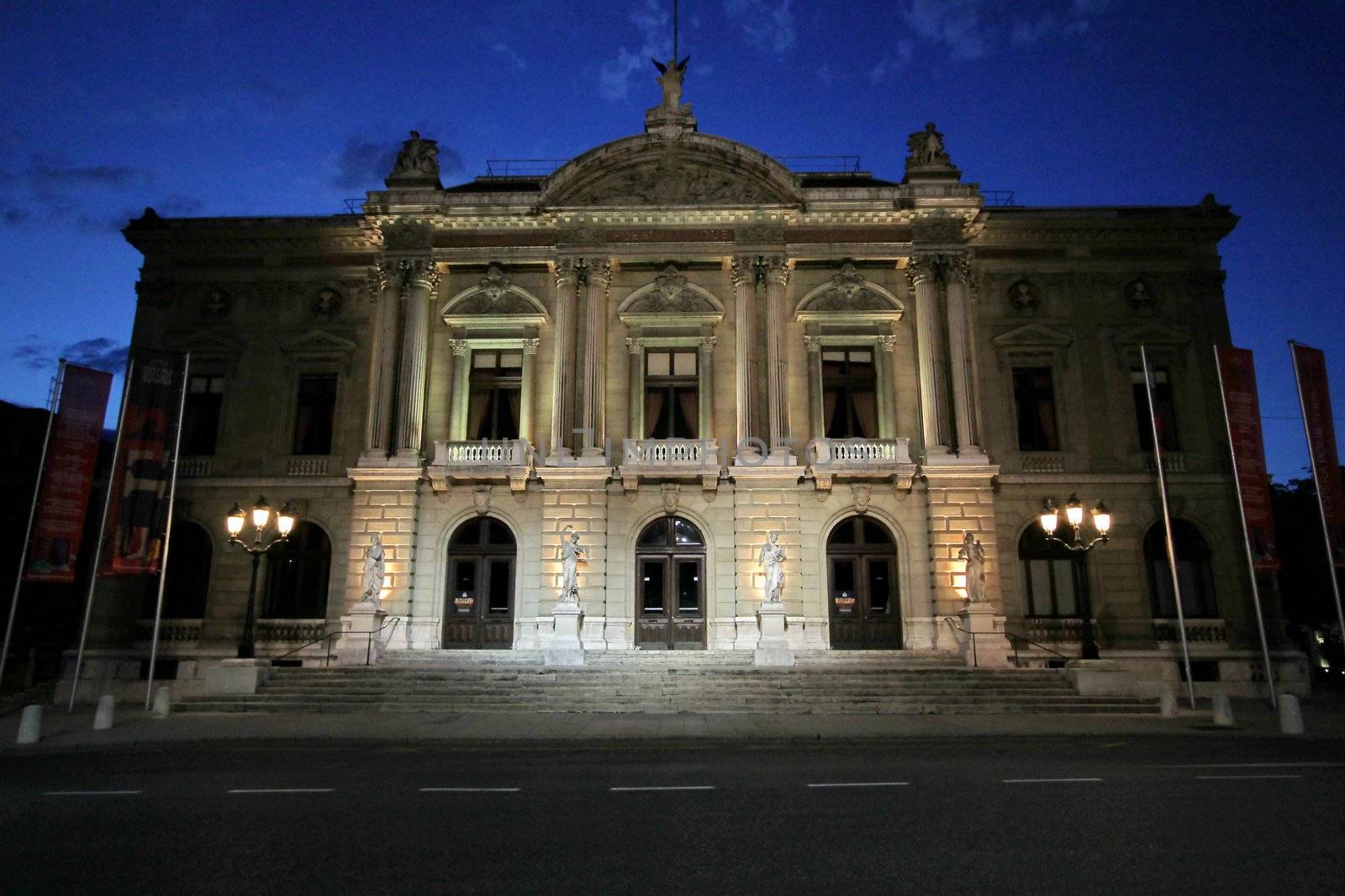 Facade of the Big Theater at the Place Neuve by night, Geneva, Switzerland. The build of this old building ended in 1876 thanks to the Duke of Brunswick's donation. The architect Jacques-Elisee Goss was inspired by the Opera Garnier in Paris, France.