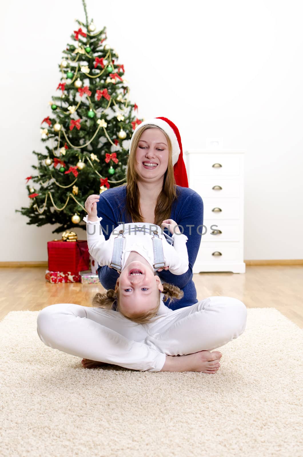 Little girl and her mom having fun at Christmas
