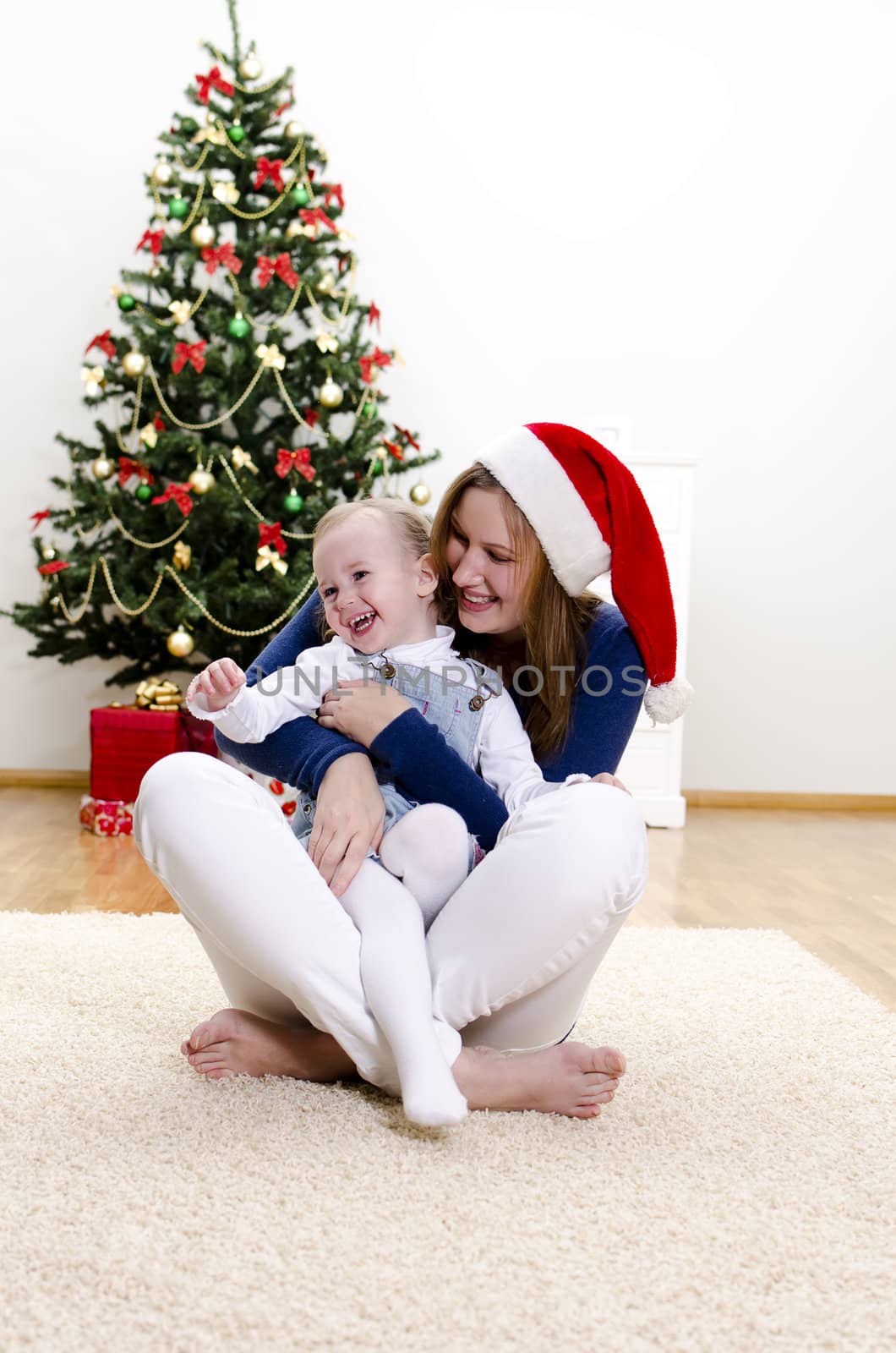Little girl and her mom having fun at Christmas by dmitrimaruta