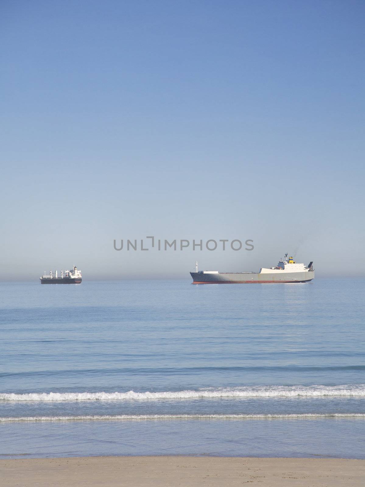 Shipping boats at sea near the beach