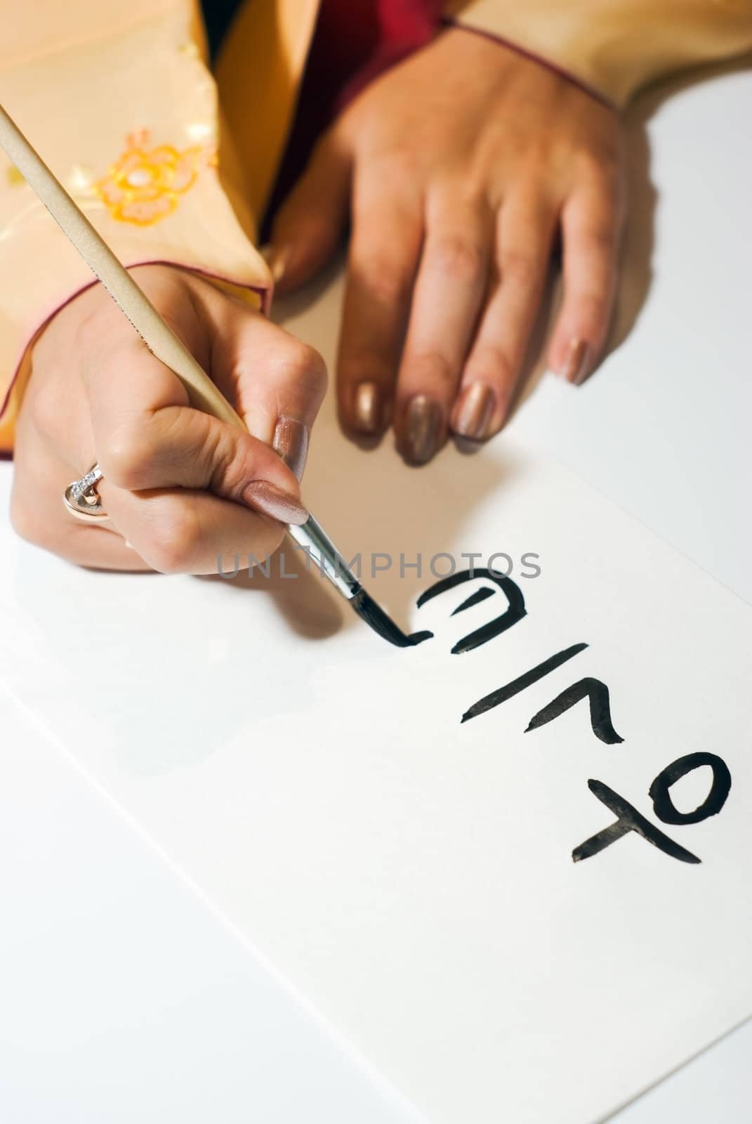 Korean girl write the word on paper close up