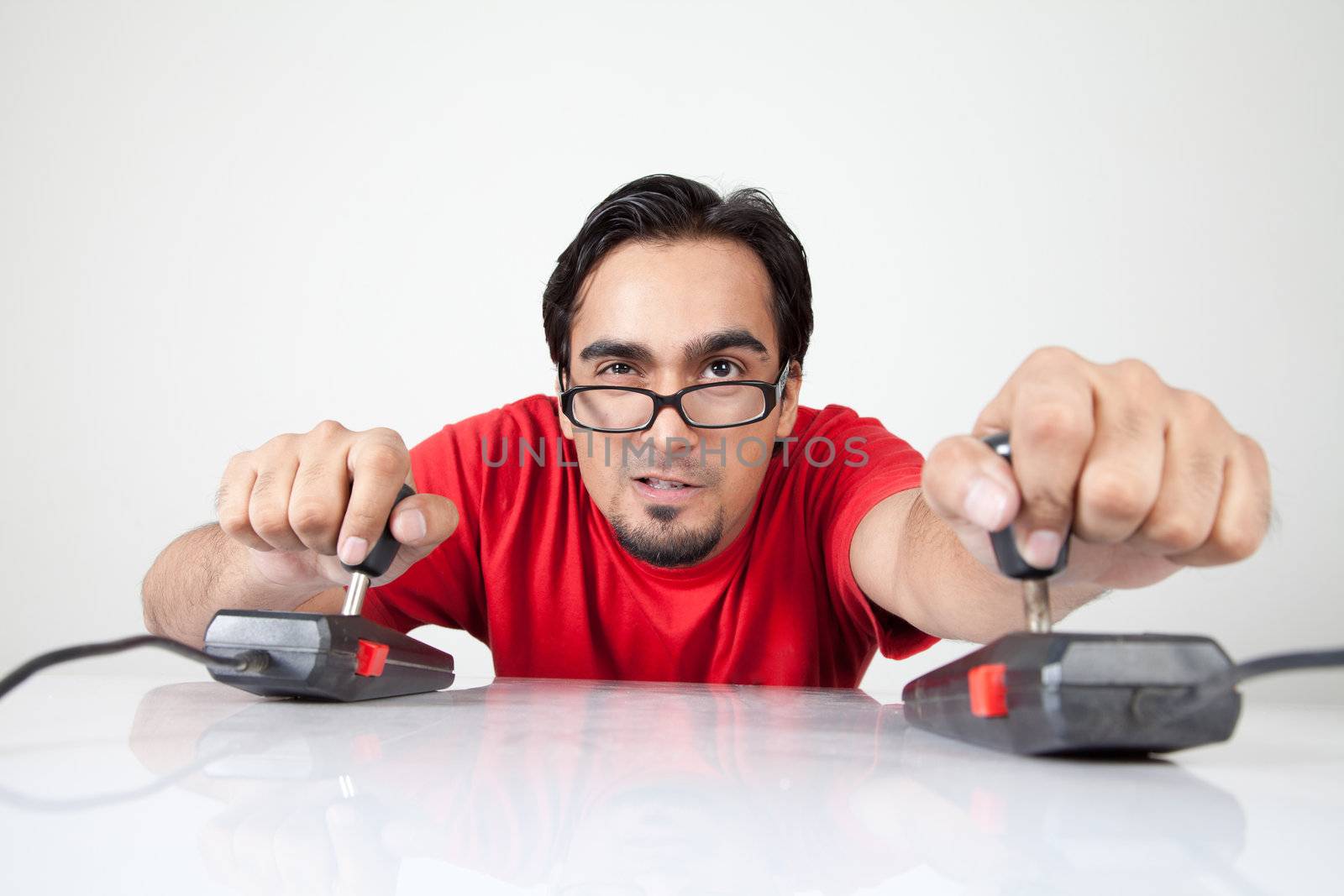 Game nerd playing with two joysticks by haiderazim
