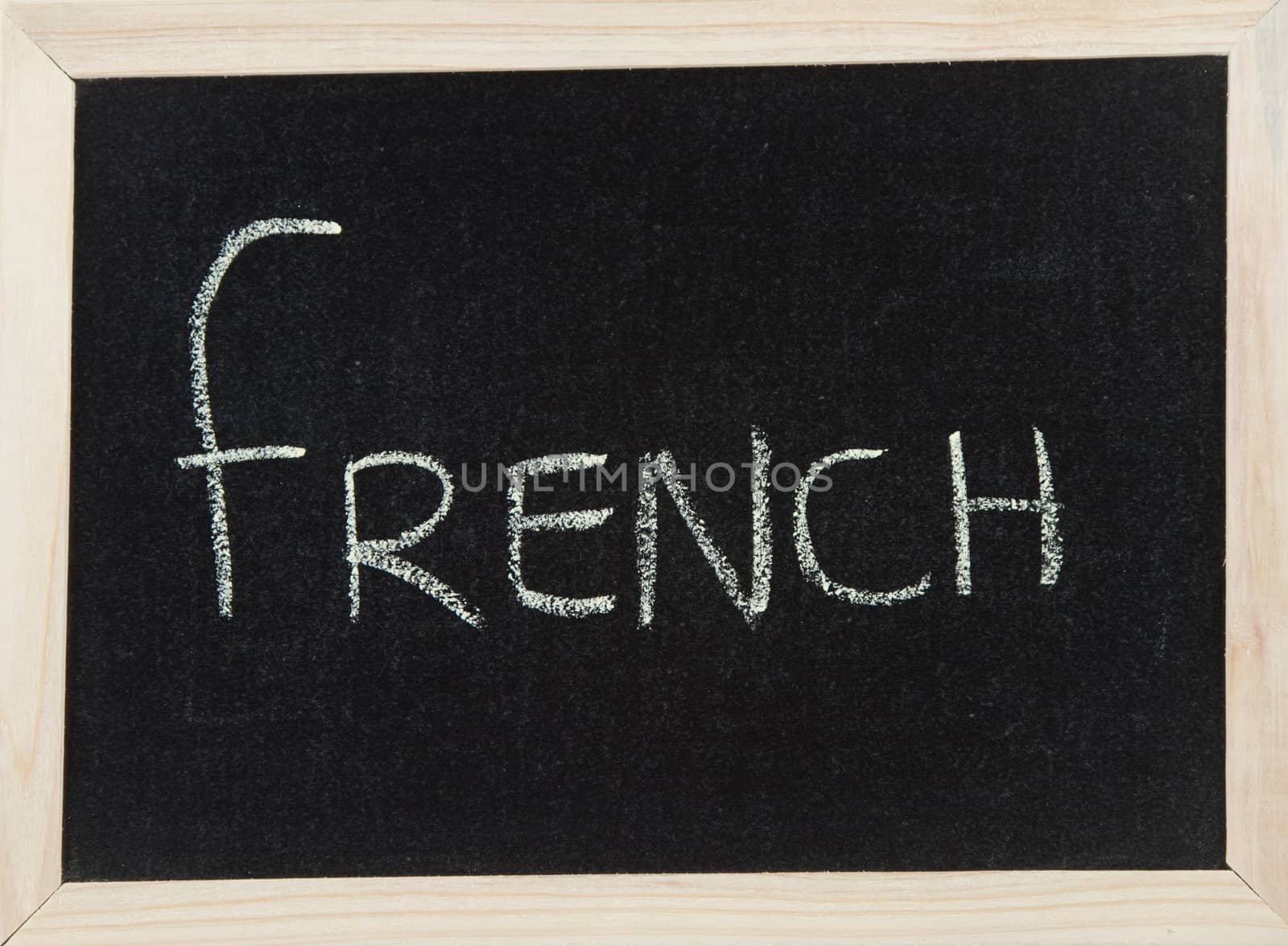 A black board with a wooden frame and the word 'FRENCH' written in chalk.