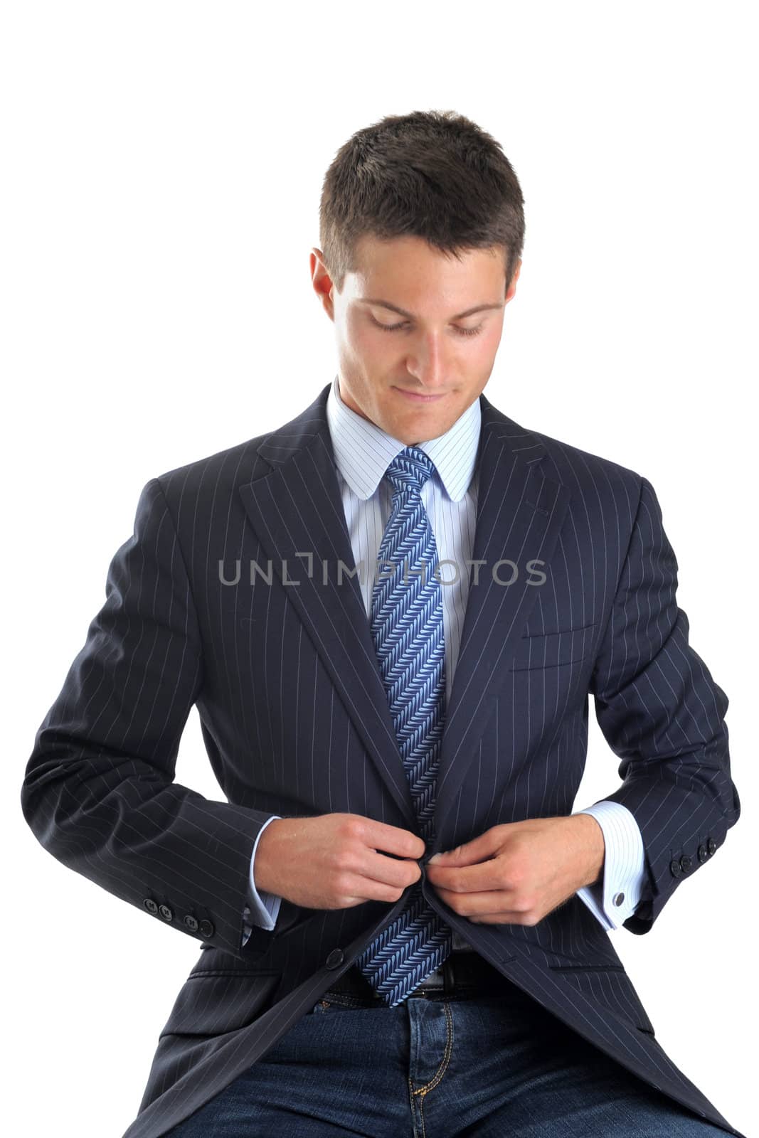 young business man button his jacket in front of white background