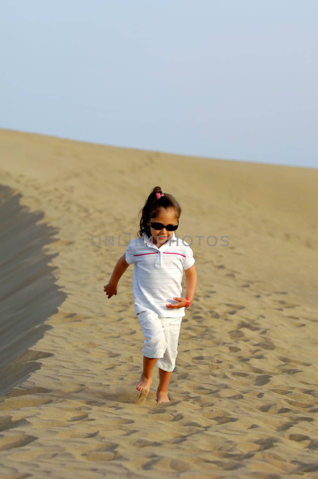 Happy child all alone in the desert