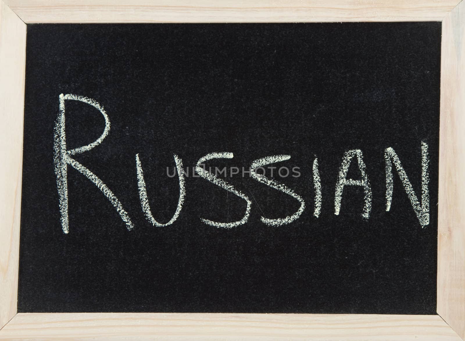 A black board with a wooden frame and the word 'RUSSIAN' written in chalk.
