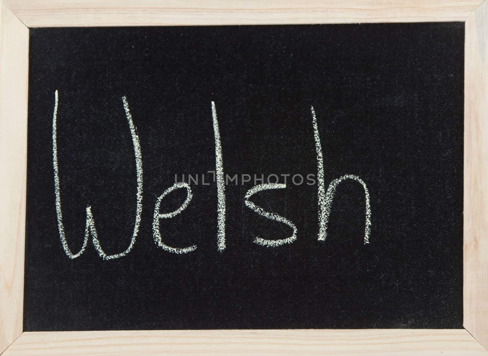 A black board with a wooden frame and the word 'WELSH' written in chalk.