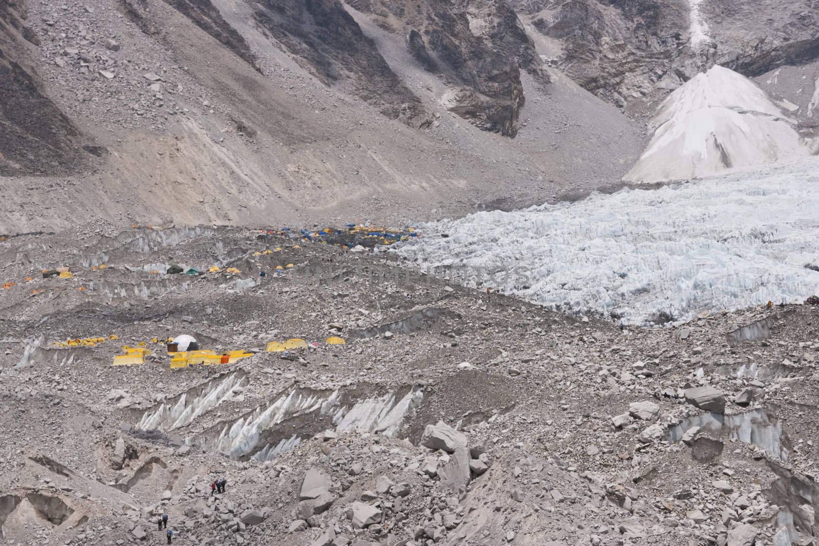 Everest Base Camp. Cluster of yellow tents on the rubble strewn Khumbu glacier at the base of Mount Everest, Nepal