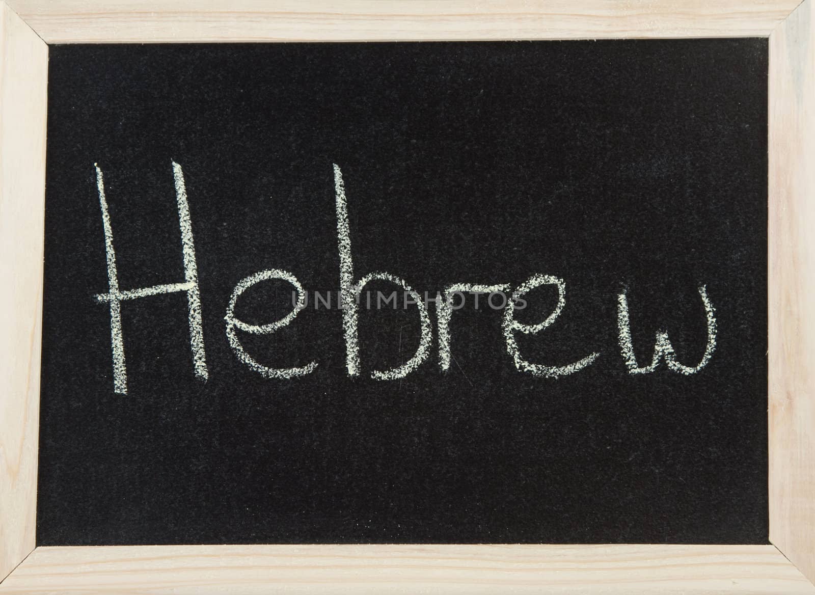 A black board with a wooden frame and the word 'HEBREW' written in chalk.