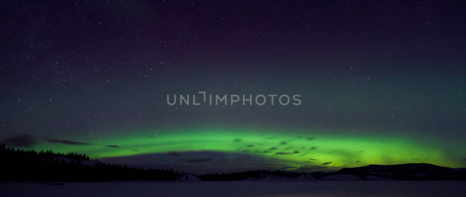 Colorful northern lights (aurora borealis) substorm on dark night sky with myriads of stars.