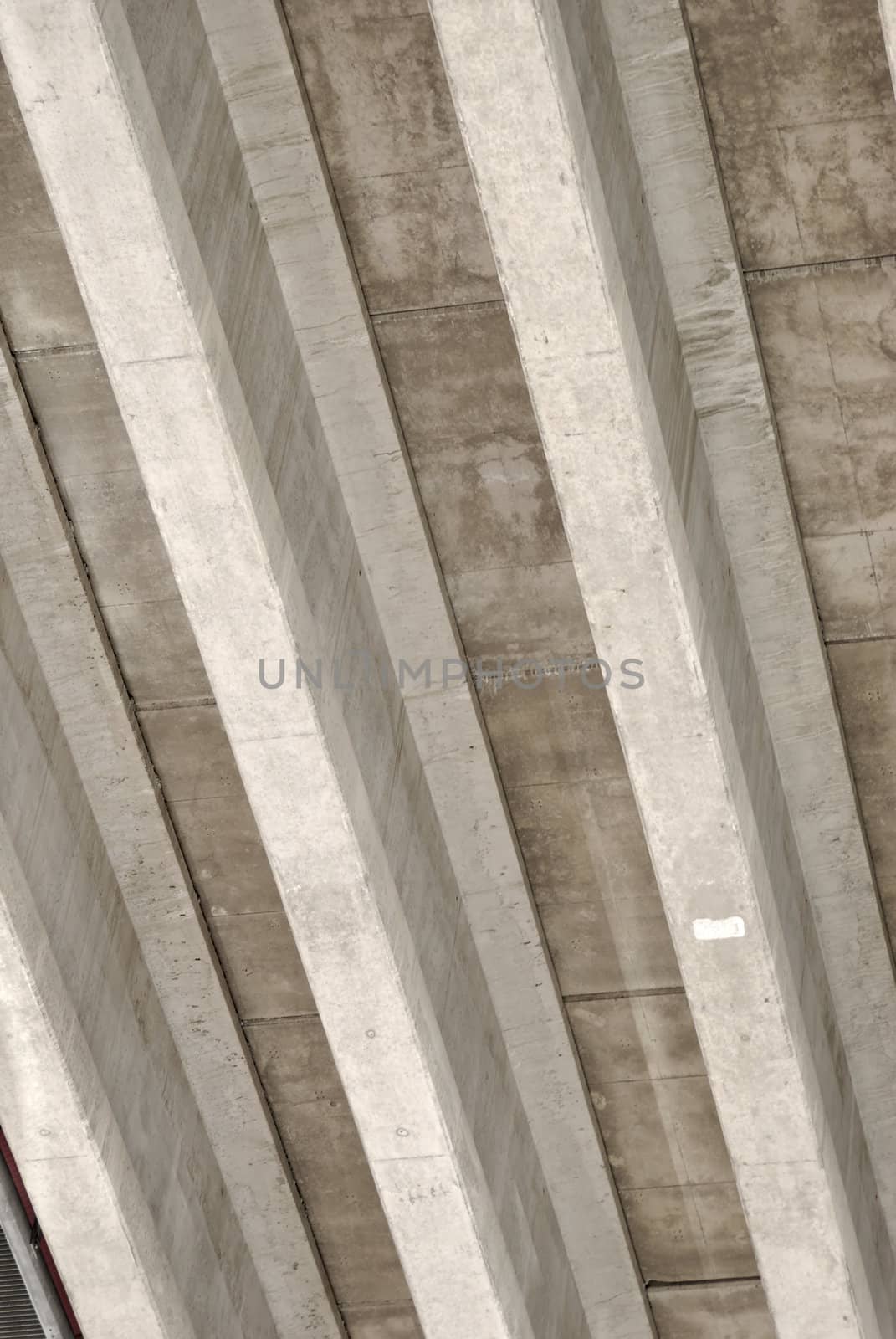 Underside of a highway bridge, forming abstract concrete stripes.
