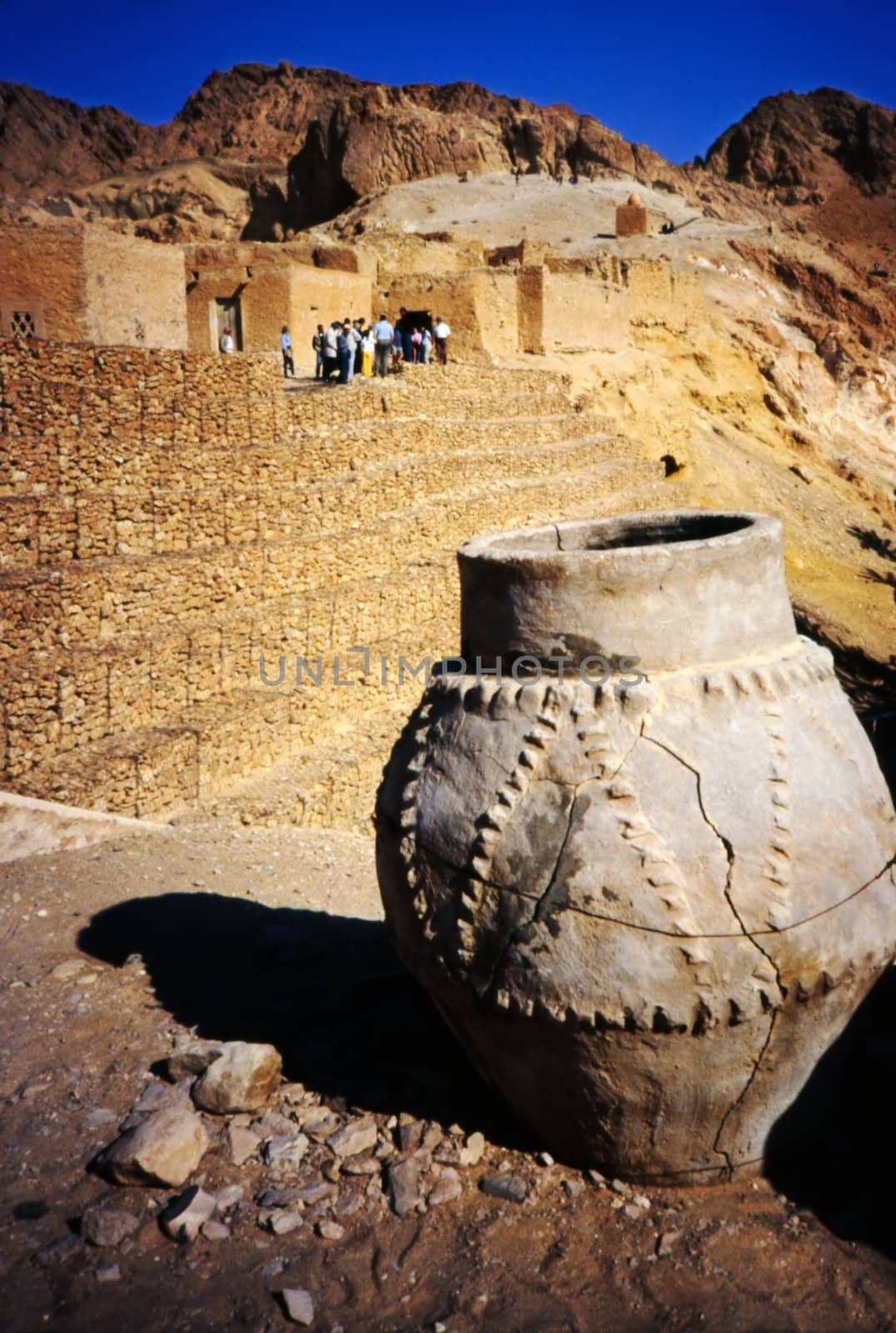 Tunisian vase with desert, tourists and ruins in the background
