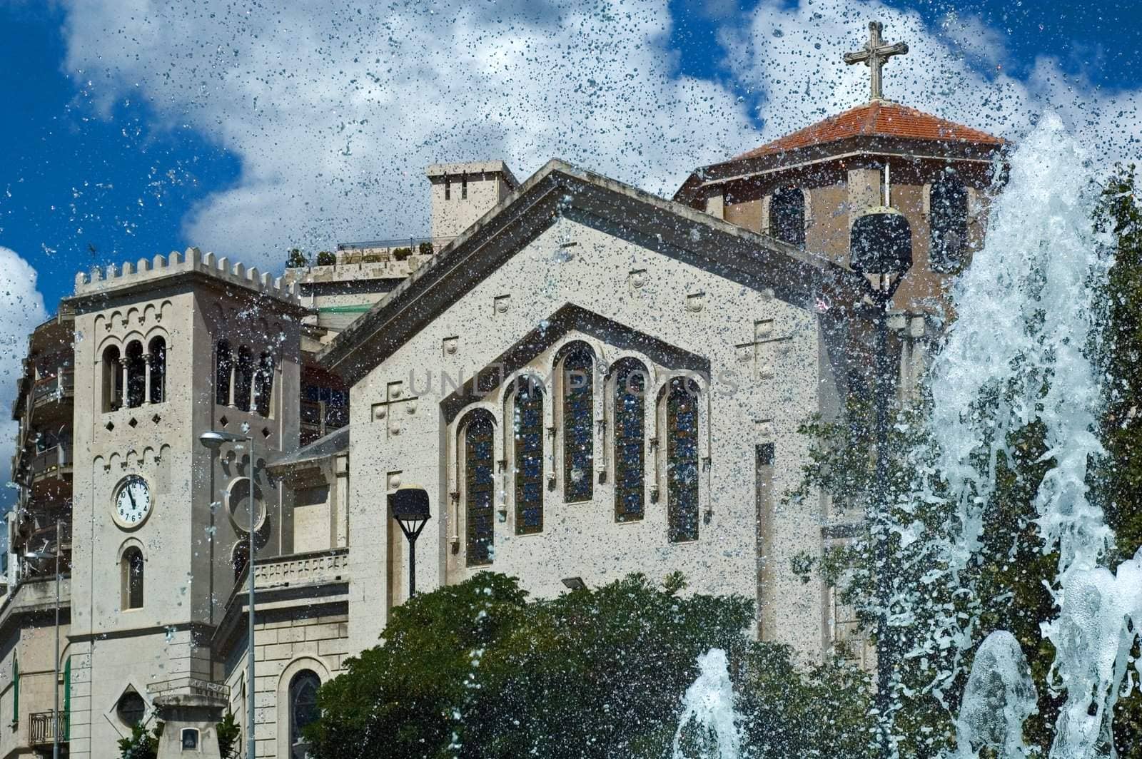 Church with fountain sprays on sunny day