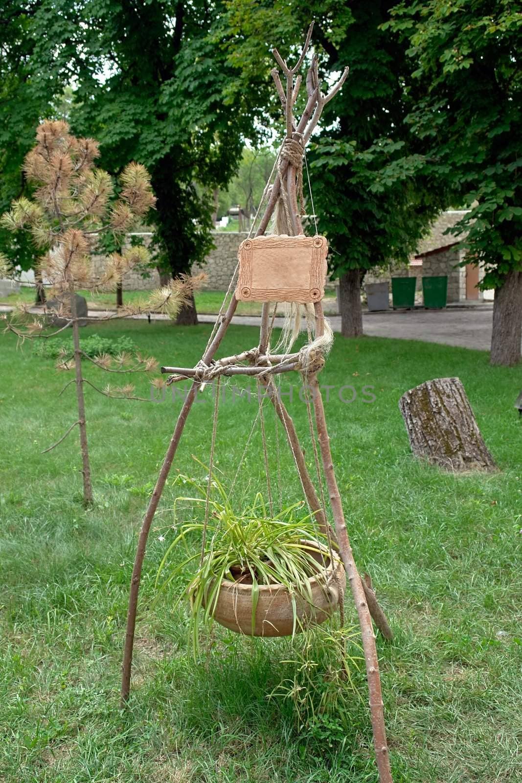 Original flower pot in the summer park. Above table for the inscription.