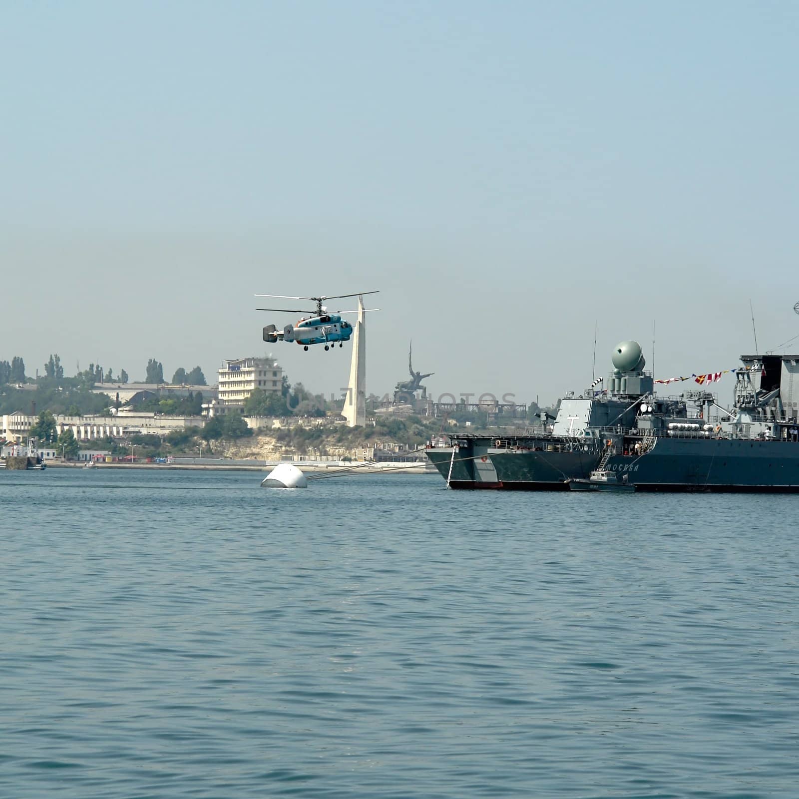 Large helicopter lands aboard the warship