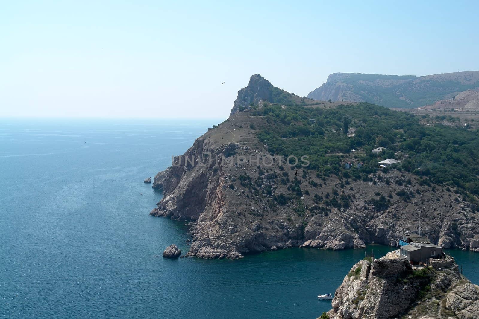 Large rock with sea and sky at background