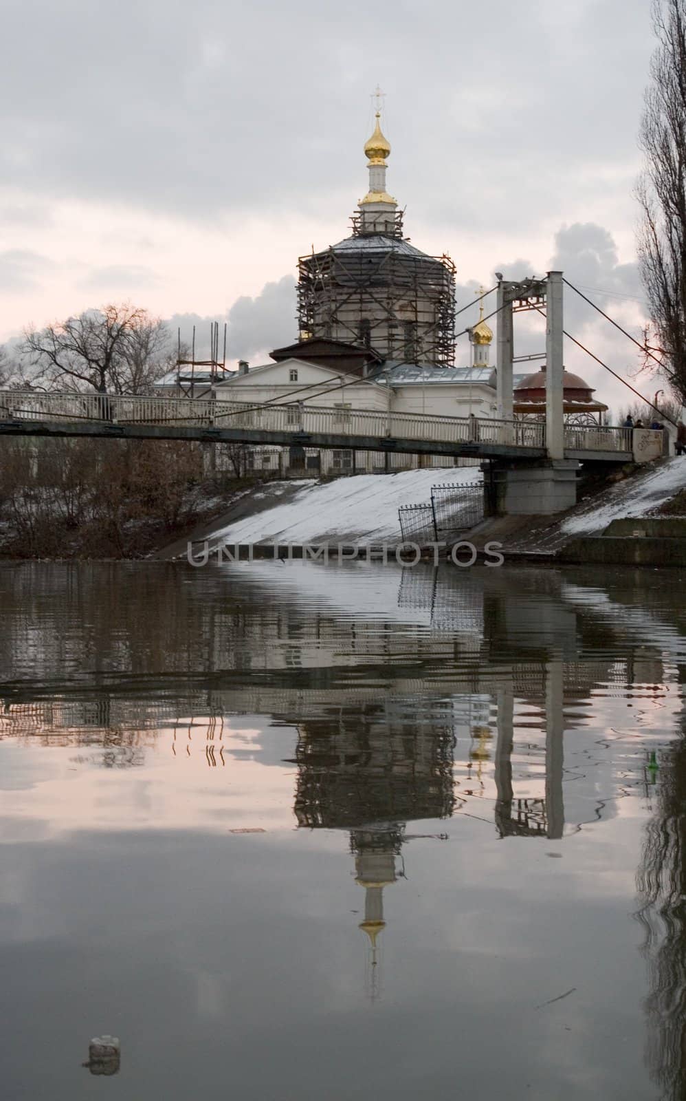 The orthodox temple is reflected in the spring river