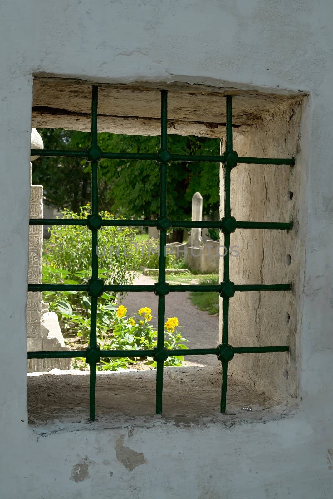 View through the lattice on the old quiet cemetery