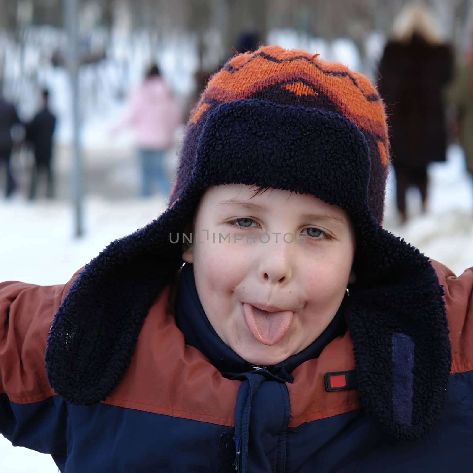 A little boy sticks one's tongue out
