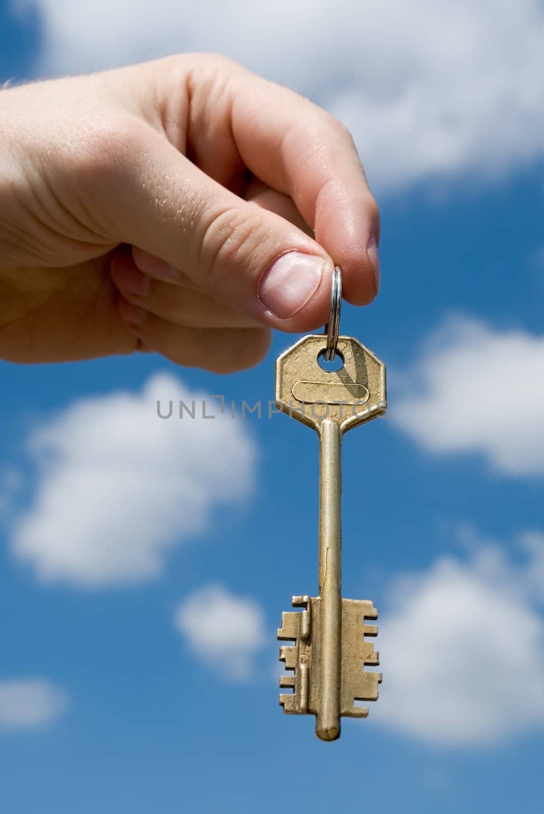 hand transfers the key with sky at background