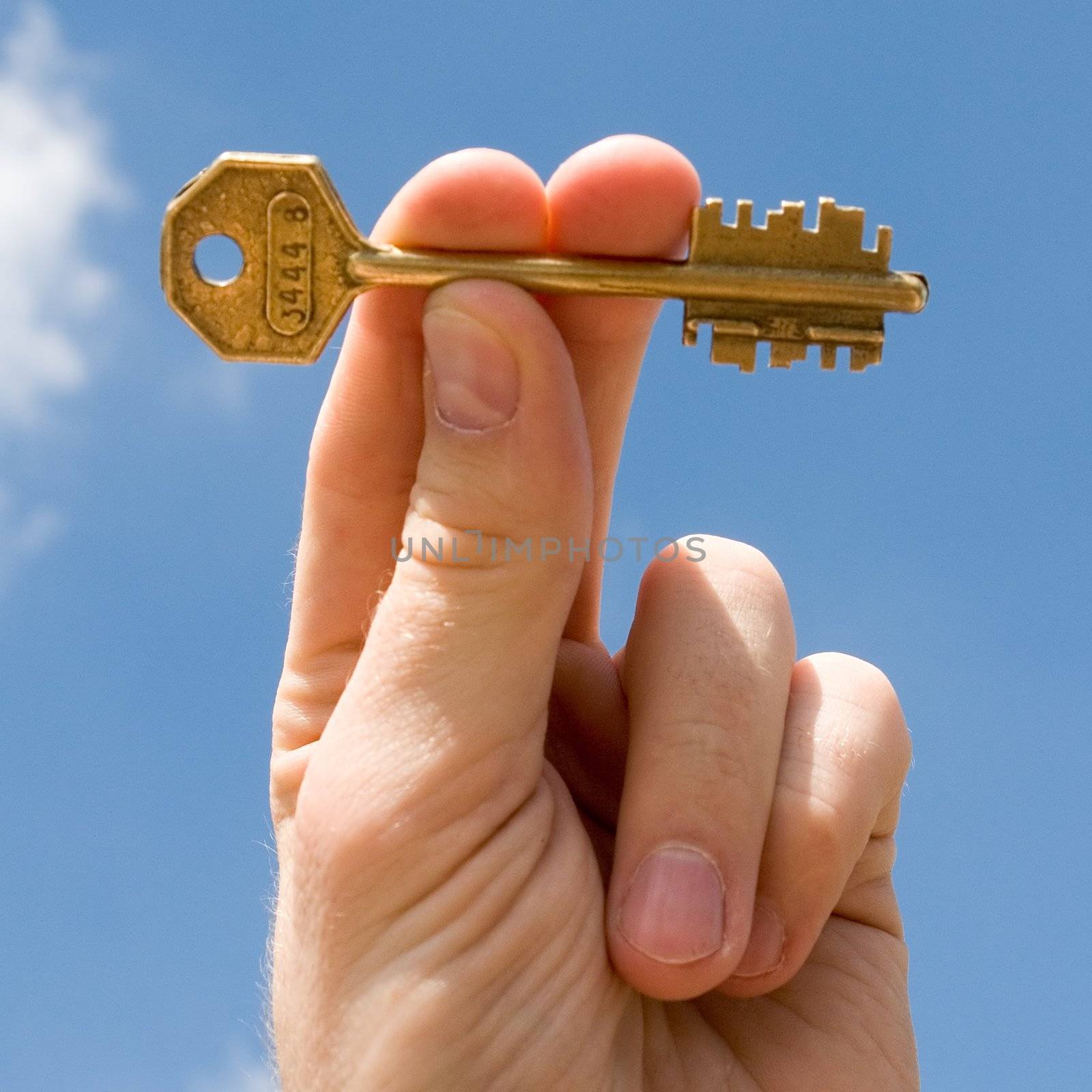 hand transfers the key with sky at background